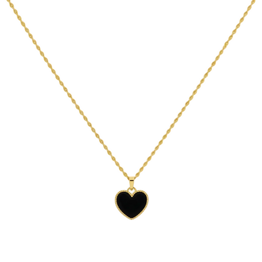 Gold necklace with a black heart pendant on a white background