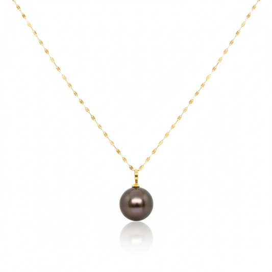 Gold necklace with a dark pearl pendant on a white background