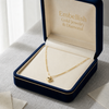 Gold necklace in a 'Embellish Gold Jewelry & Diamond' box on a light surface.