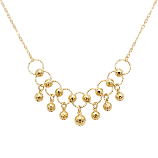 Gold necklace with circular links and spherical pendants on a transparent background