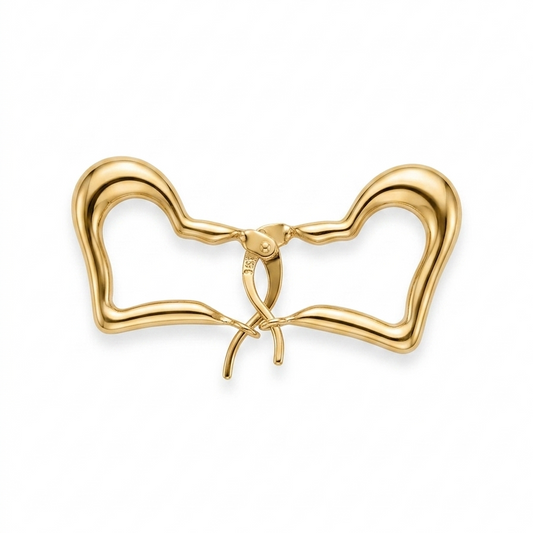 Gold bow-shaped jewelry on a white background