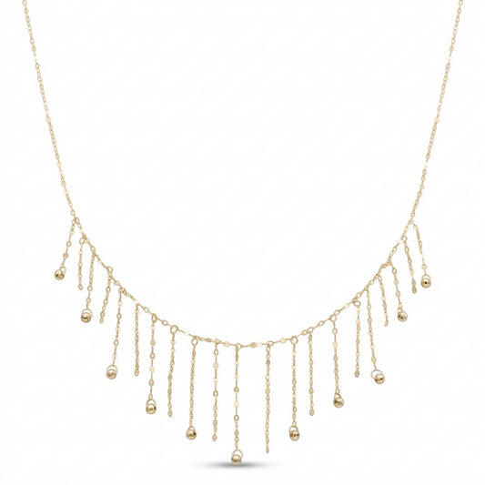 Gold necklace with dangling beads on a white background