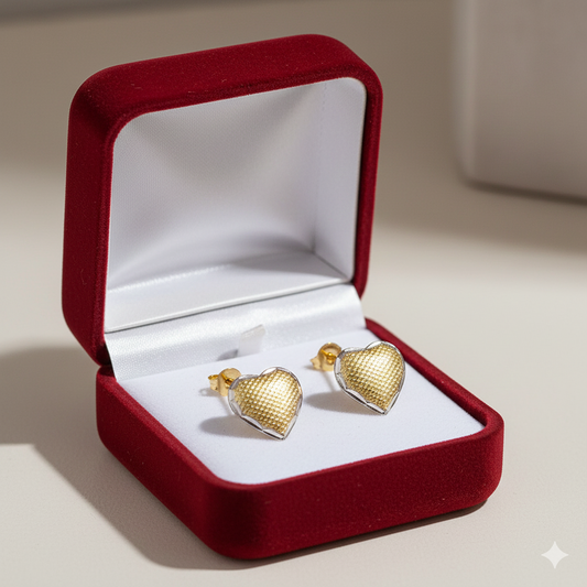 Heart-shaped gold stud earrings in a red velvet jewelry box