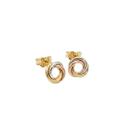 Pair of gold and silver spiral earrings on a white background