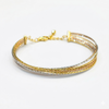 Gold and silver bracelet on a white background
