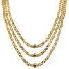 Three gold chains stacked on a white background