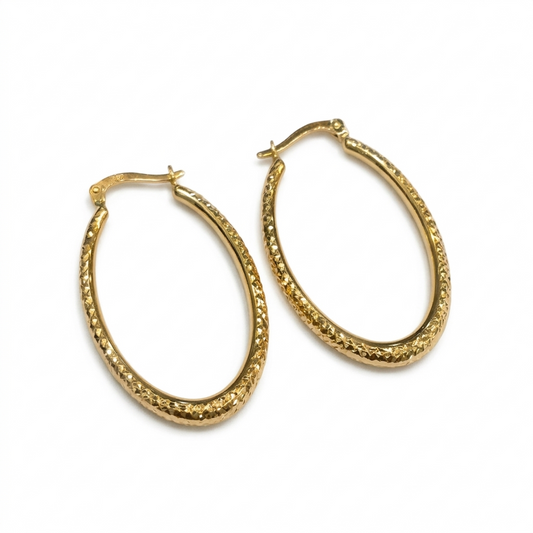 Gold hoop earrings on a white background