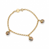 Gold bracelet with three spherical charms on a white background