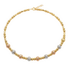 Gold, rose gold, and silver beaded necklace on a white background
