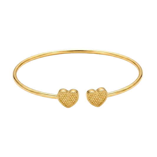 Gold bangle with heart-shaped ends on a white background