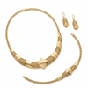 Gold necklace and earrings set on a white background