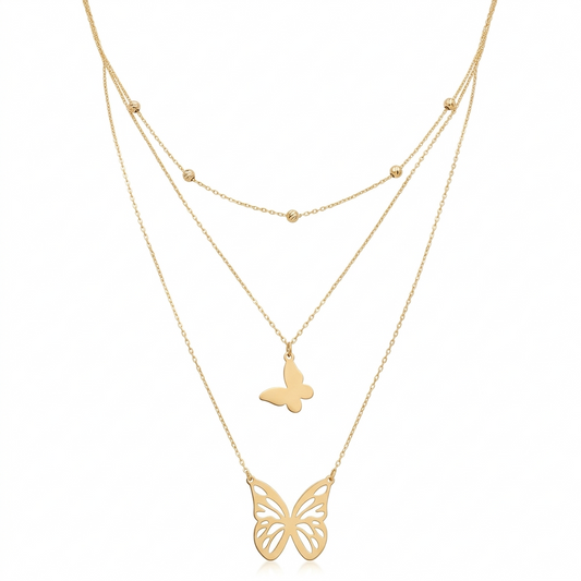 Gold butterfly necklace on a white background