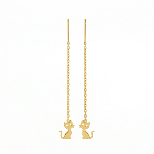 Gold cat-shaped earrings on thin chains against a white background