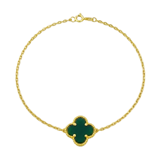 Gold bracelet with a green clover-shaped clasp on a white background