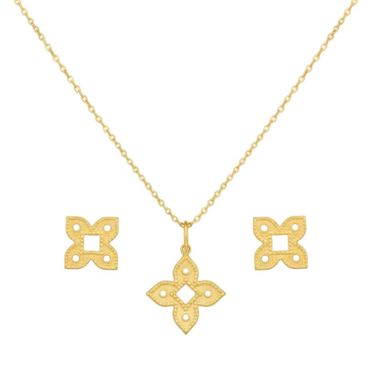 Gold necklace with matching earrings on a white background