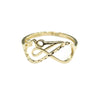 Gold ring with intricate design on a gray background