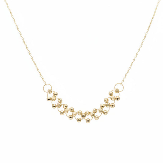 Gold necklace on a mannequin with weight label