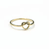 Gold ring with a knot design on a gray background