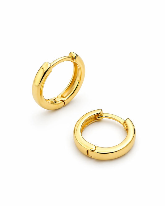 Gold hoop earrings on a white background