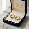 Gold necklace in an open jewelry box with 'Embellish Gold Jewelry & Diamond' branding.