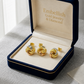 Gold knot earrings in a 'Embellish Gold Jewelry & Diamond' box on a gray surface.