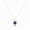 Necklace with a purple bead pendant on a gold chain against a white background