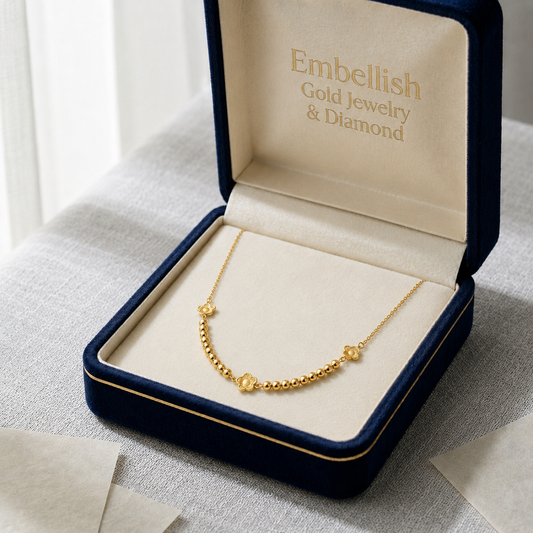Gold necklace in an open jewelry box with 'Embellish Gold Jewelry & Diamond' branding.