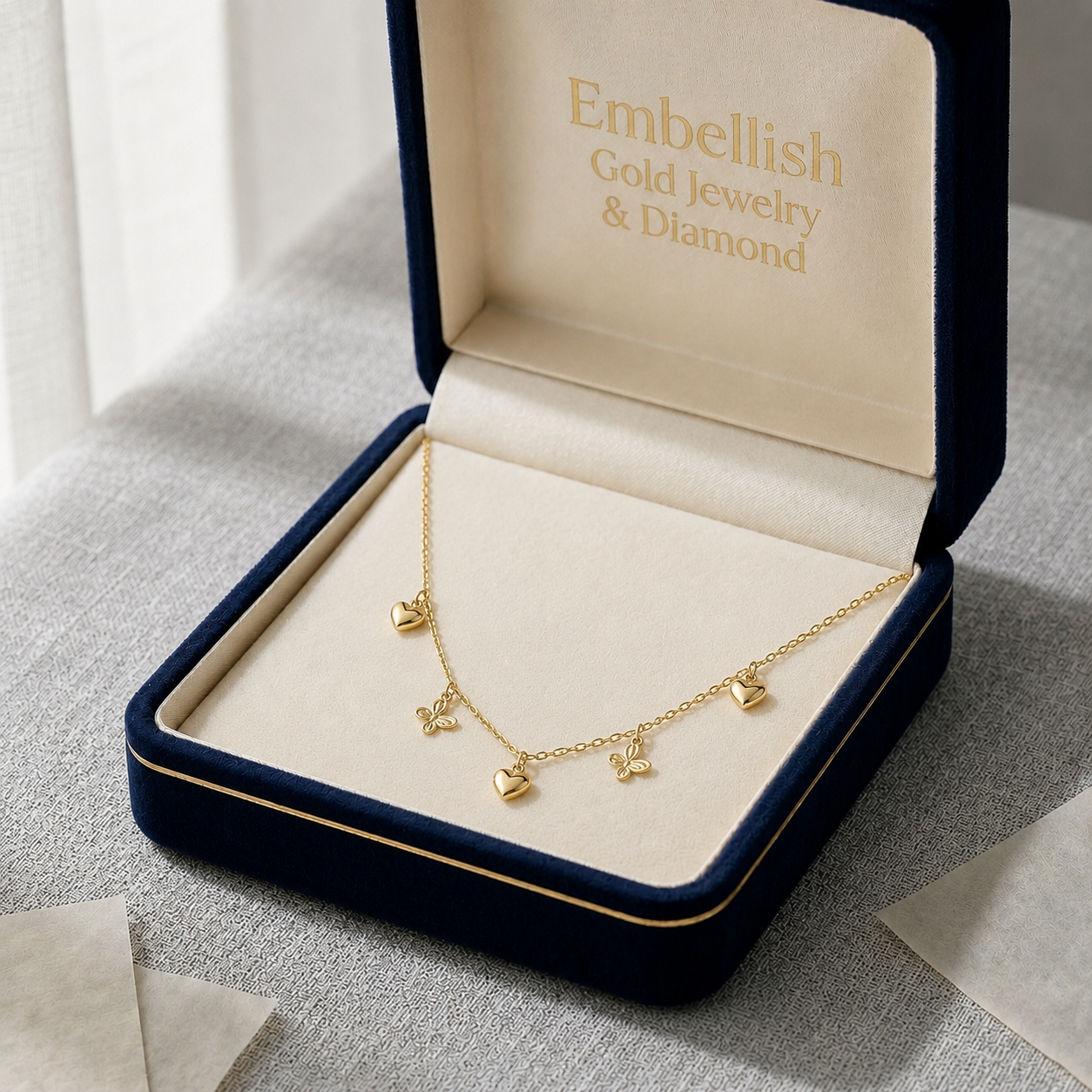 Gold ring in a 'Embellish Gold Jewelry & Diamond' box on a textured surface