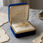 Gold ring in a blue and gold jewelry box with 'Embellish Gold Jewelry & Diamond' branding.