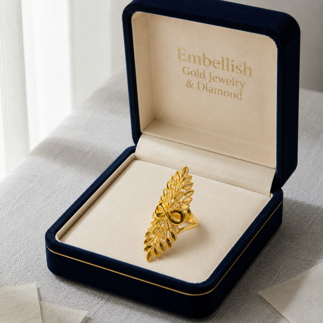 Gold jewelry in a 'Embellish Gold Jewelry & Diamond' box on a light background