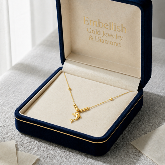 Gold necklace in an open jewelry box with 'Embellish Gold Jewelry & Diamond' branding.