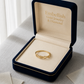 Gold ring in an open jewelry box with 'Embellish Gold Jewelry & Diamond' branding.
