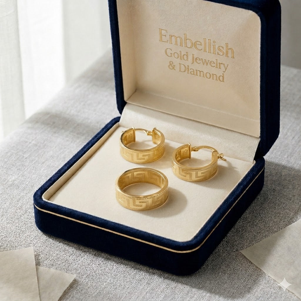 Gold hoop earrings in a 'Embellish Gold Jewelry & Diamond' box on a textured surface.