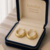 Gold hoop earrings in a 'Embellish Gold Jewelry & Diamond' box.