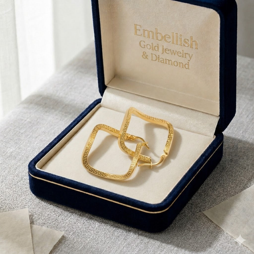 Gold jewelry set in a 'Embellish Gold Jewelry & Diamond' box on a textured surface.