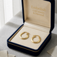 Gold hoop earrings in a 'Embellish Gold Jewelry & Diamond' box on a light surface.
