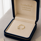 Gold ring in a 'Embellish Gold Jewelry & Diamond' box on a neutral background