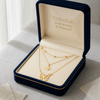 Gold necklace in a 'Embellish Gold Jewelry & Diamond' box on a light background