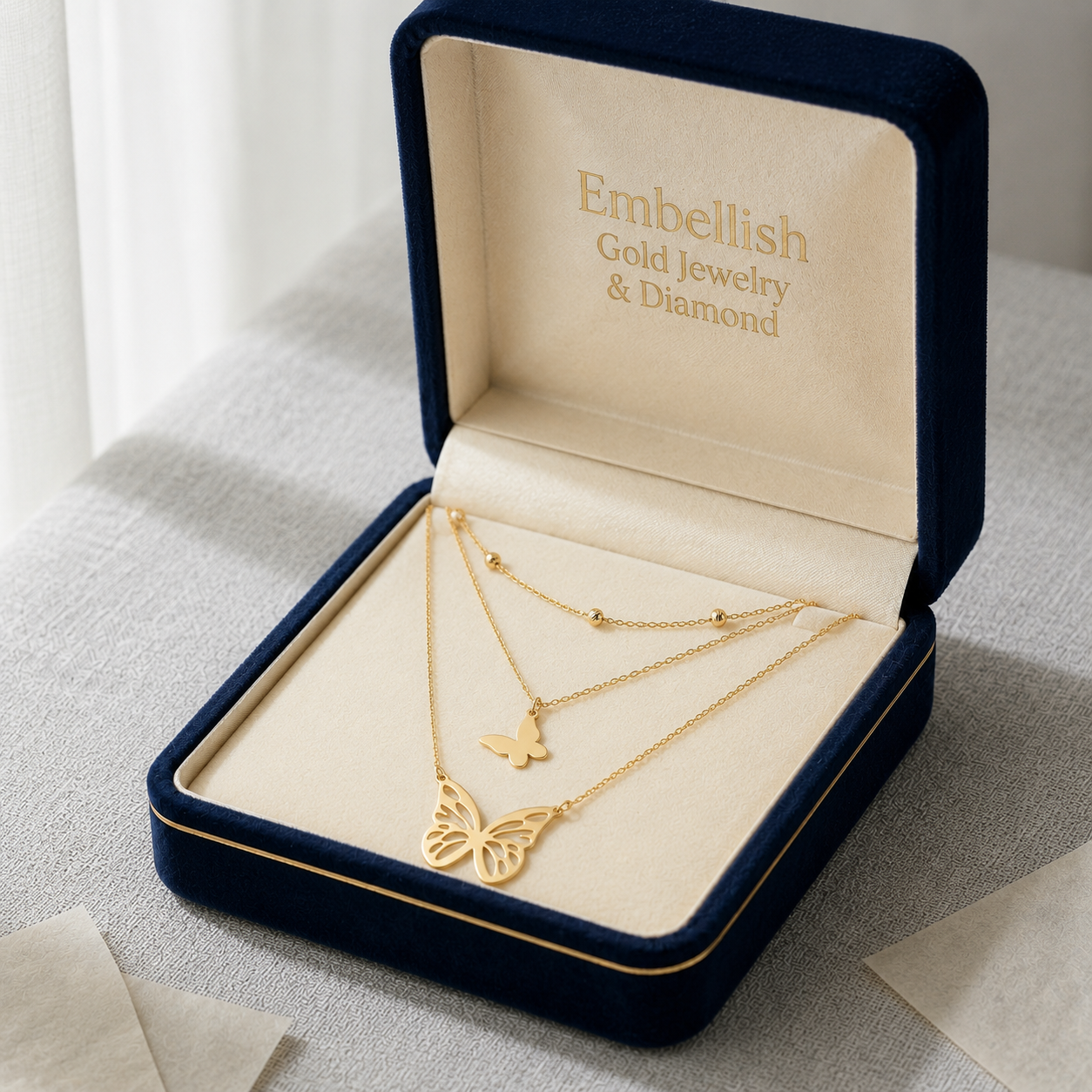 Gold necklace in a 'Embellish Gold Jewelry & Diamond' box on a light background