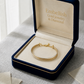 Gold bracelet in an open jewelry box with 'Embellish Gold Jewelry & Diamond' branding.