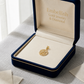 Gold pendant in an open jewelry box with 'Embellish Gold Jewelry & Diamond' branding.