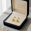 Gold earrings in a 'Embellish Gold Jewelry & Diamond' box on a light background