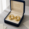 Gold hoop earrings in a 'Embellish Gold Jewelry & Diamond' box on a light surface.