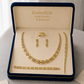 Gold jewelry set including necklace, bracelet, and earrings in a 'Embellish' box.