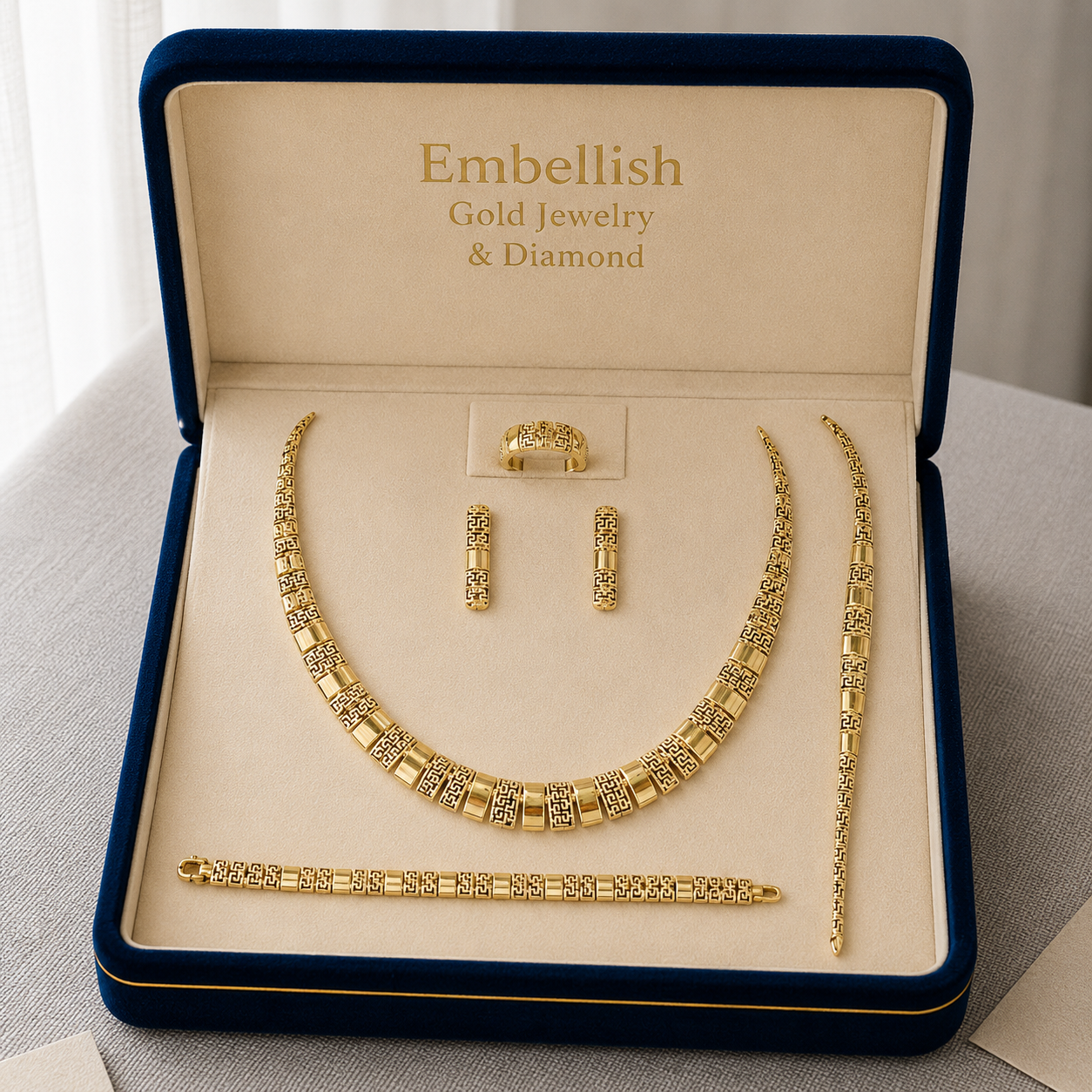 Gold jewelry set including necklace, bracelet, and earrings in a 'Embellish' box.