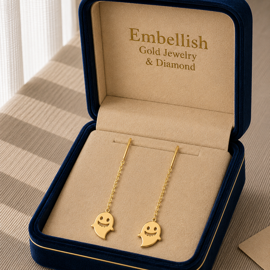 Gold ghost-shaped earrings in a 'Embellish Gold Jewelry & Diamond' box.