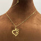Gold necklace with three interlocking heart pendants on delicate chain, displayed on bust