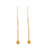 Pair of gold earrings with small spherical beads on a light gray background