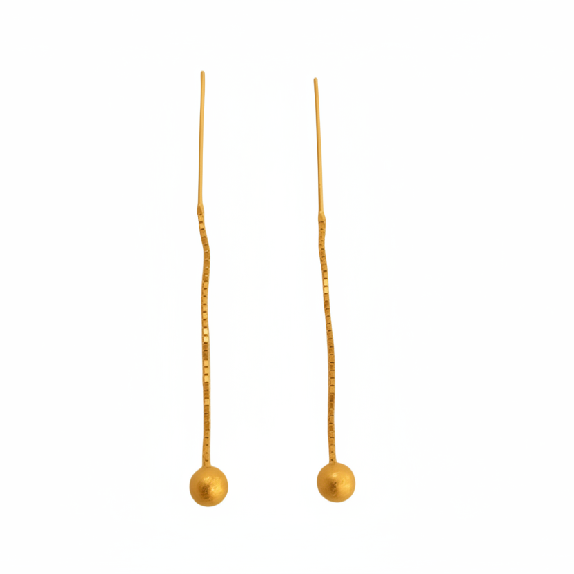 Pair of gold earrings with small spherical beads on a light gray background