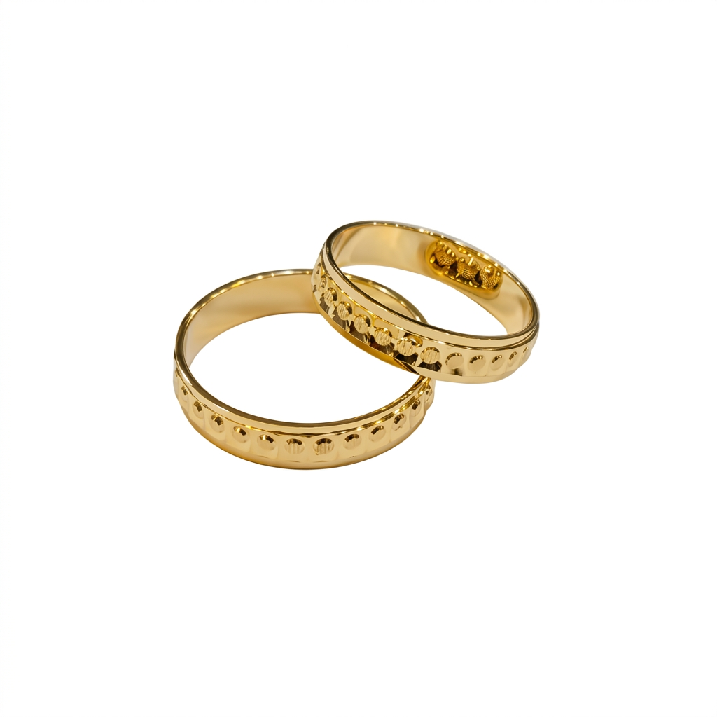 Two gold rings with textured design on a white background